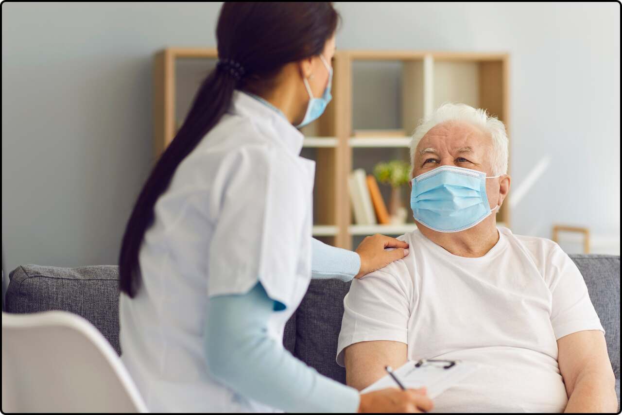 Woman Doctor comforting a old male patient by gently touching his shoulder.